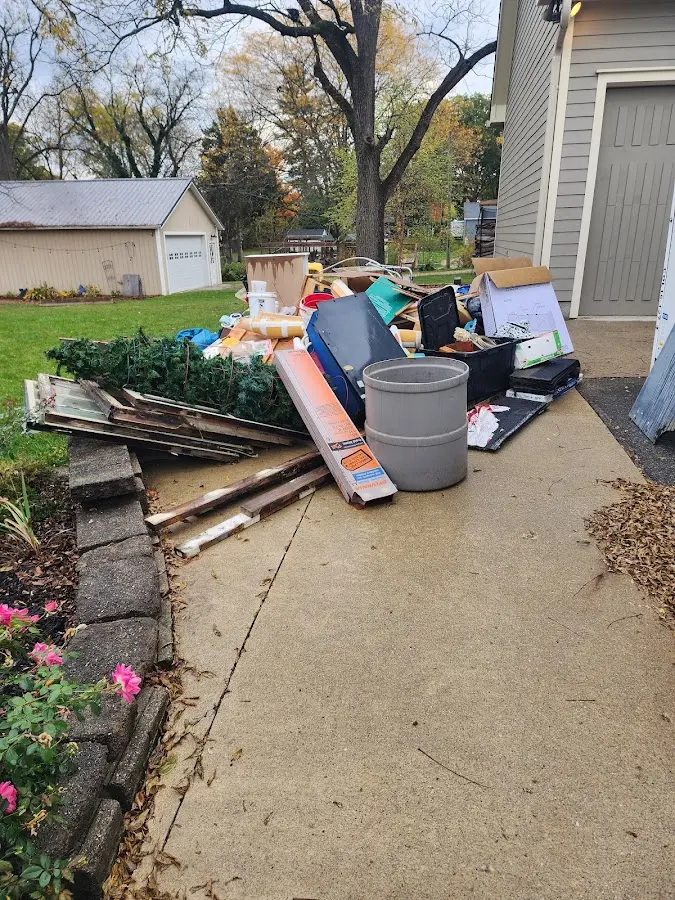 Dumpster being loaded with debris for Estate Cleanout Dumpster Rental in Brunswick